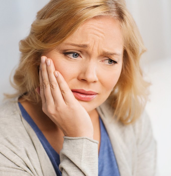Woman worrying about dental implant failure in Lansing