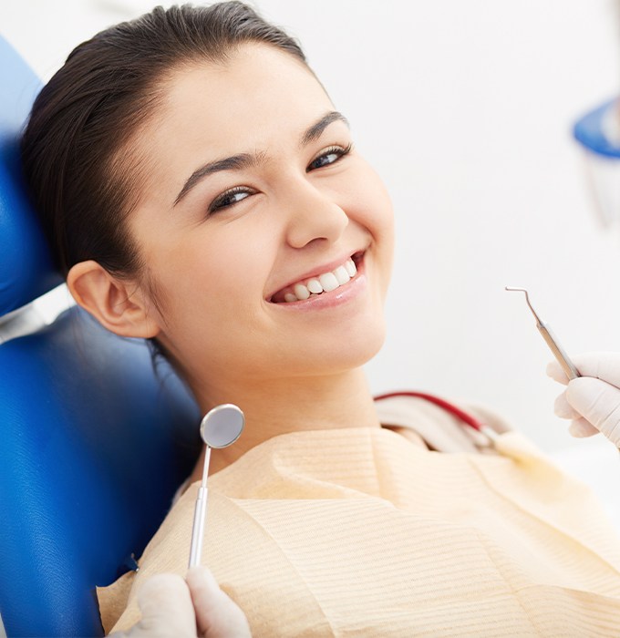 Woman in dental chair smiling