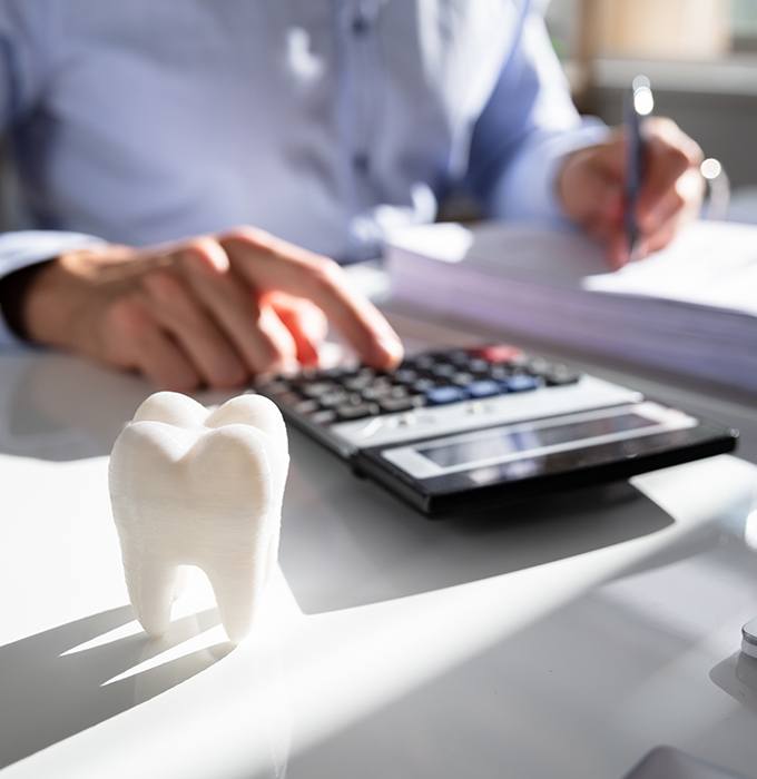 Patient calculating the cost of dental insurance