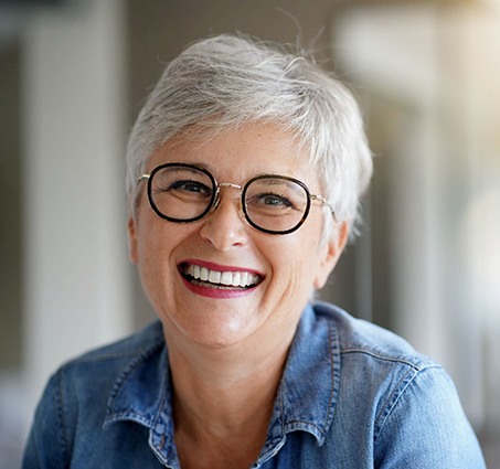 Older woman smiling after All-on-4 in Lansing, MI