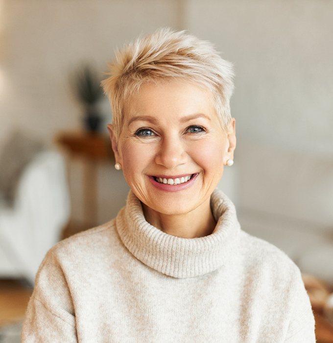 Woman in sweater smiling with All-on-4 in Lansing, MI