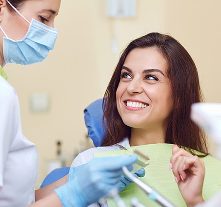 Woman talking to dentist about restorative dentistry option