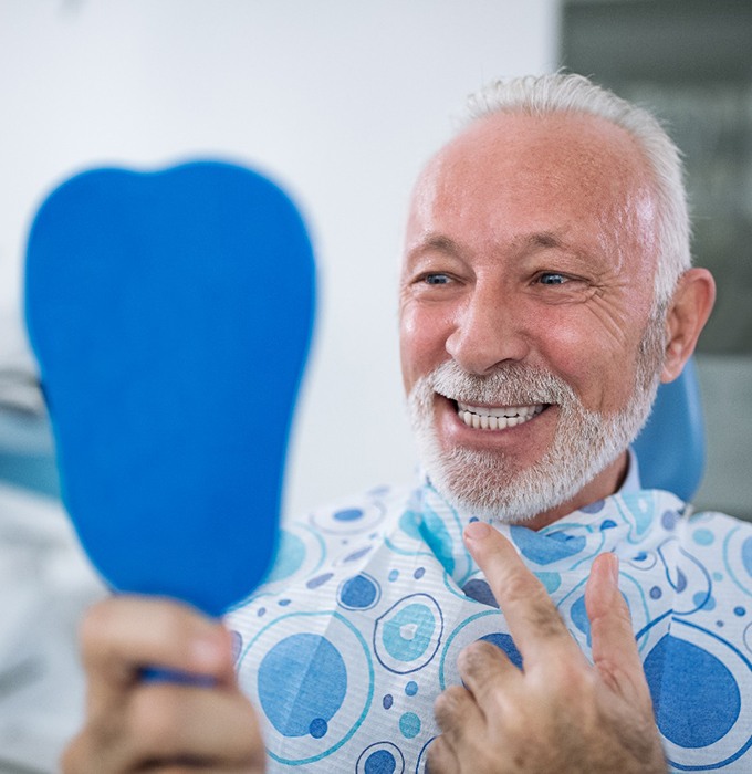 Man smiling after receiving CEREC same-day crowns