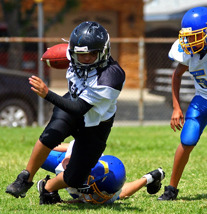 Kids playing football with custom sportsguards