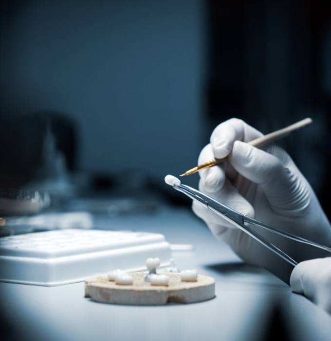 a dental technician creating a dental crown