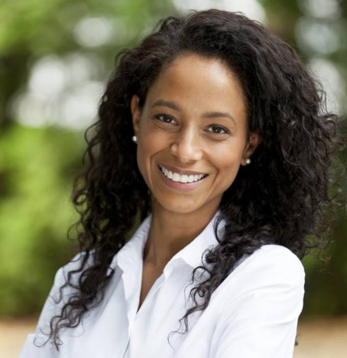 a woman smiling with her new dental crowns