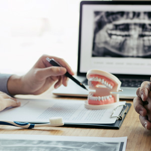 A patient and dentist discussing dentures during a consultation