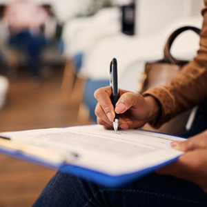 A woman filling out a dental insurance form