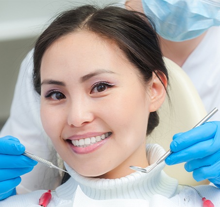 Woman smiling after emergency dentistry treatment