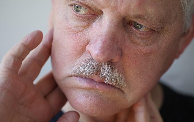 Man with toothache holding jaw