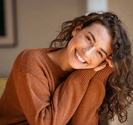 a woman in Lansing smiling after receiving tooth-colored fillings