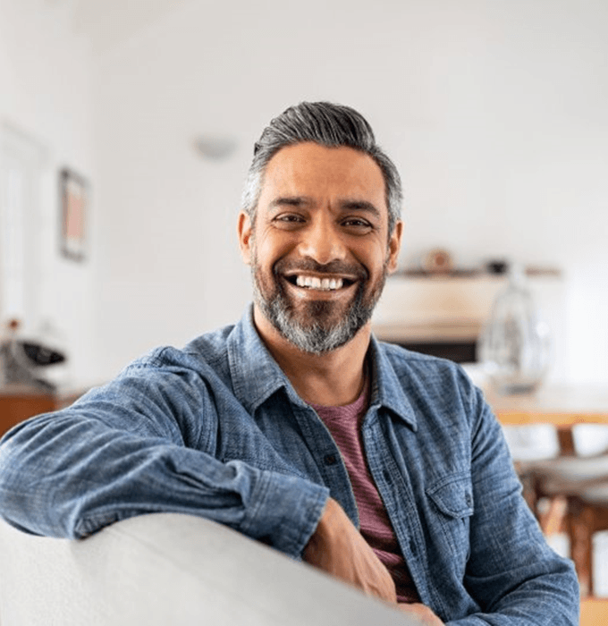 a man smiling after receiving tooth-colored fillings