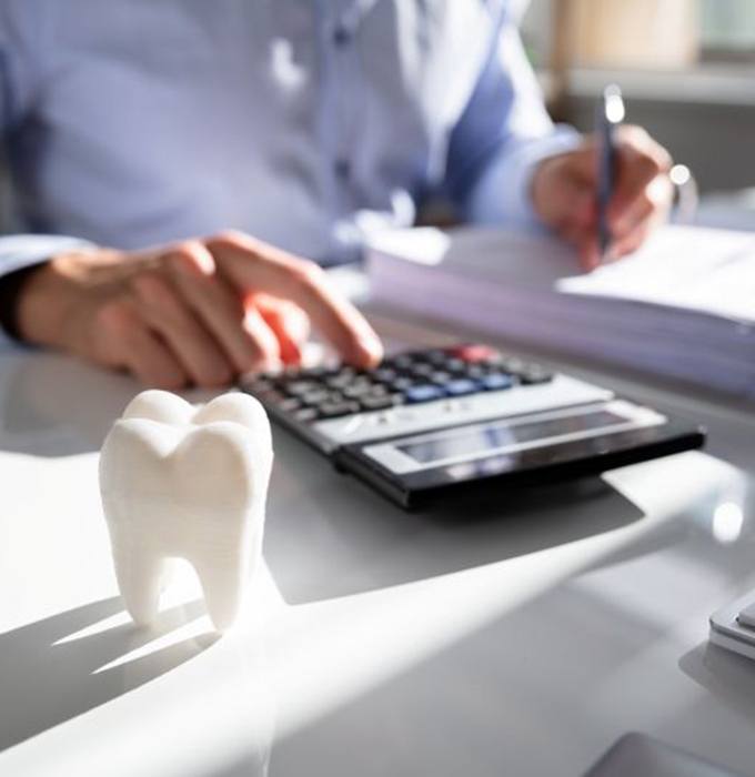 Man budgeting for the cost of dental care