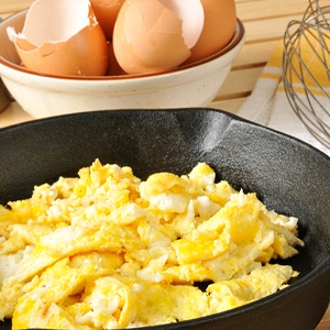 Cast iron skillet of scrambled eggs