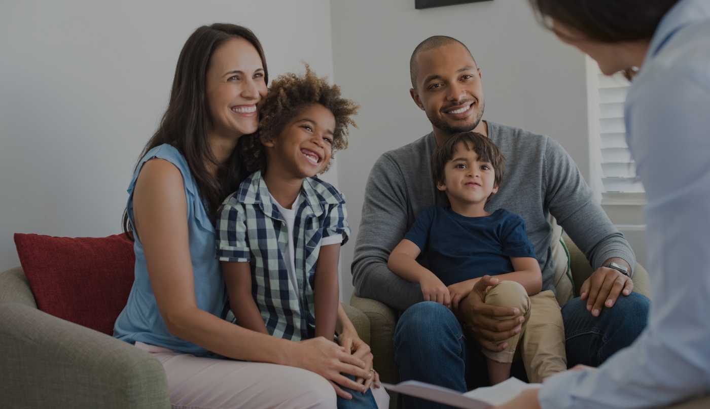 Father mother and two kids smiling during dental consultation