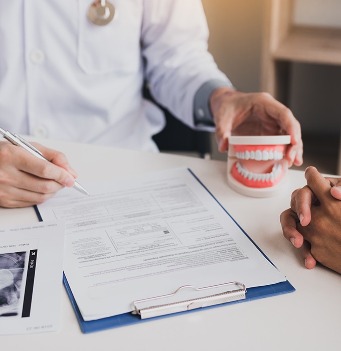 Dentist and patient reviewing dental insurance information