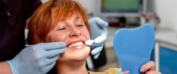Woman looking at smile during dental checkup