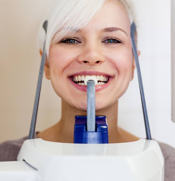 Woman receiving 3 D C T cone beam x-ray scans