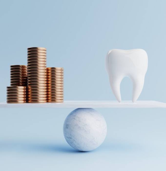 a tooth and coins representing the cost of teeth whitening
