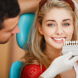 a patient smiling while undergoing teeth whitening process