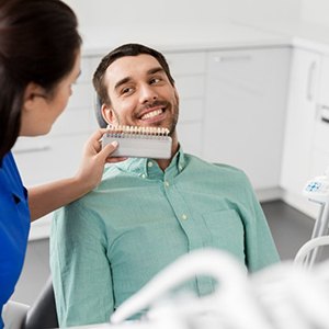 a patient smiling while undergoing the teeth whitening process