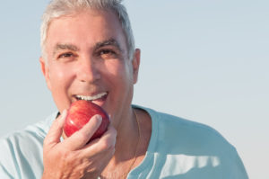 man happy with dental implants in Lansing