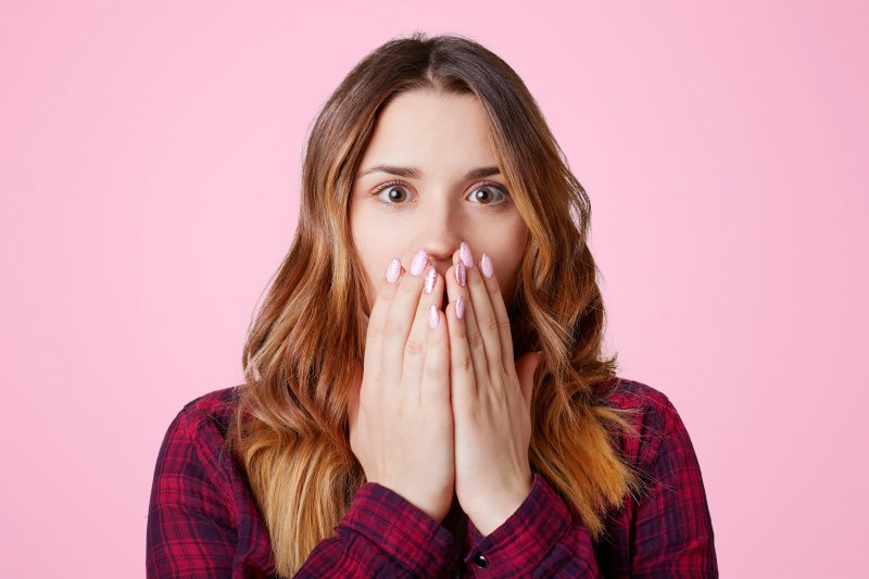 Closeup of girl covering her mouth in shock